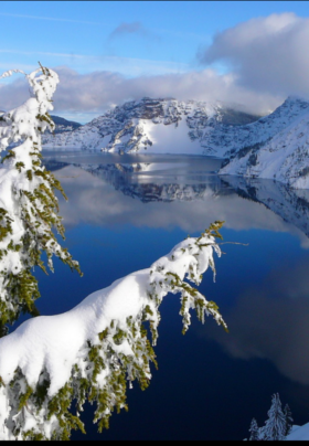 Blue lake surrounded by snowy mountains