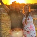 a newlywed couple celebrating with the sun setting behind them in Zimbabwe